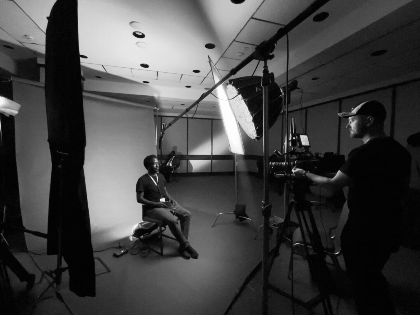 Photographer capturing a seated subject in studio