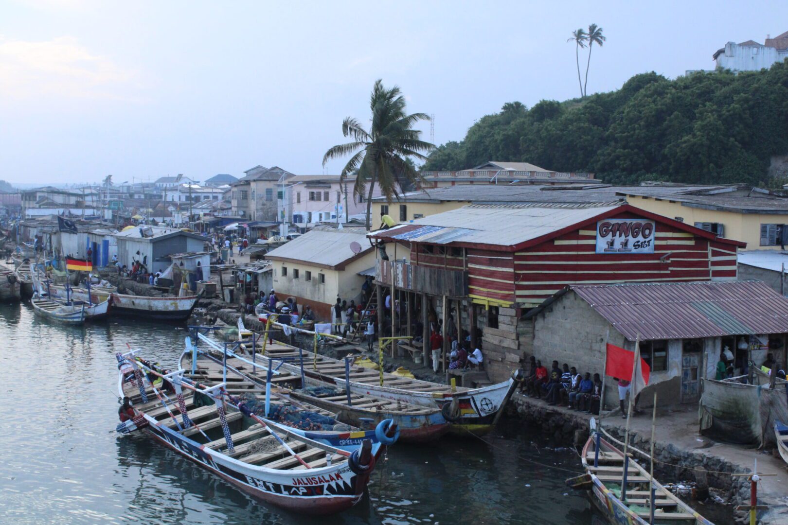 Fishing boats docked by a coastal village