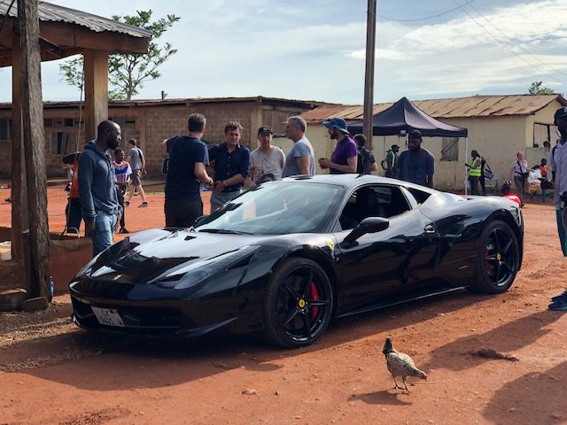 Black sports car on rural road