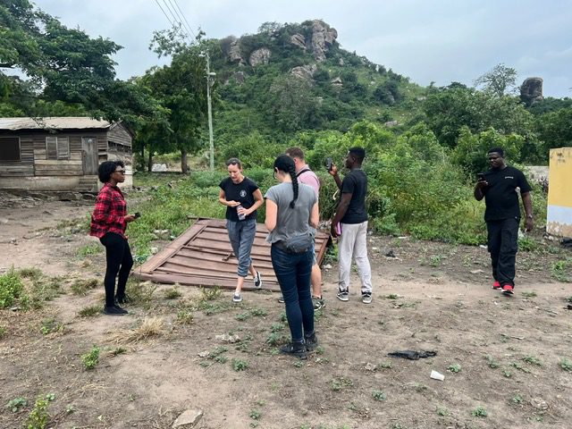Friends gathered in a scenic landscape.