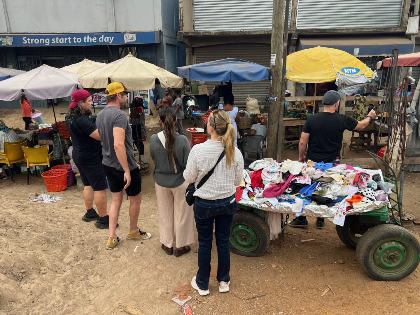 People exploring outdoor market stalls