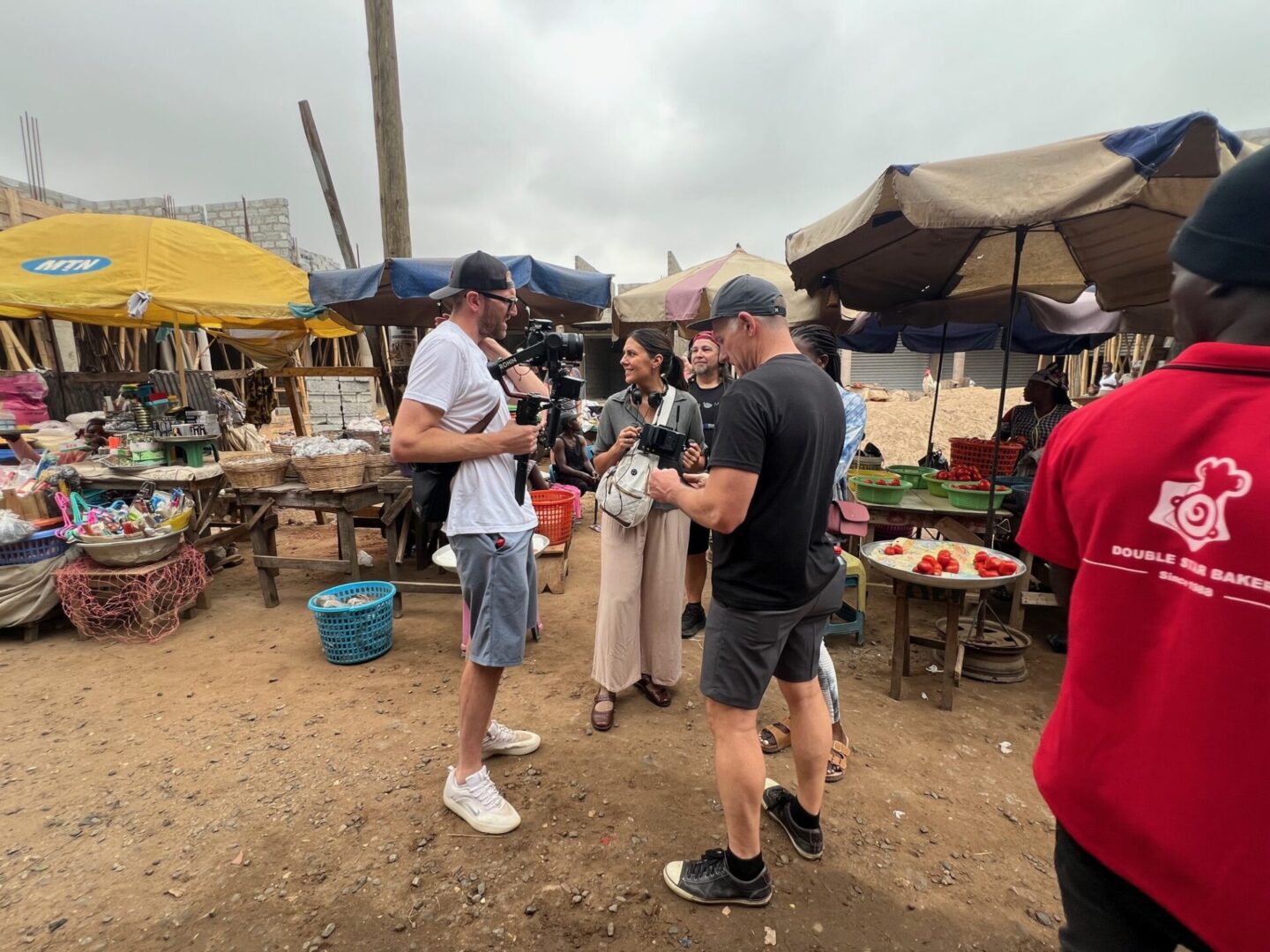 Outdoor market scene with people and stalls