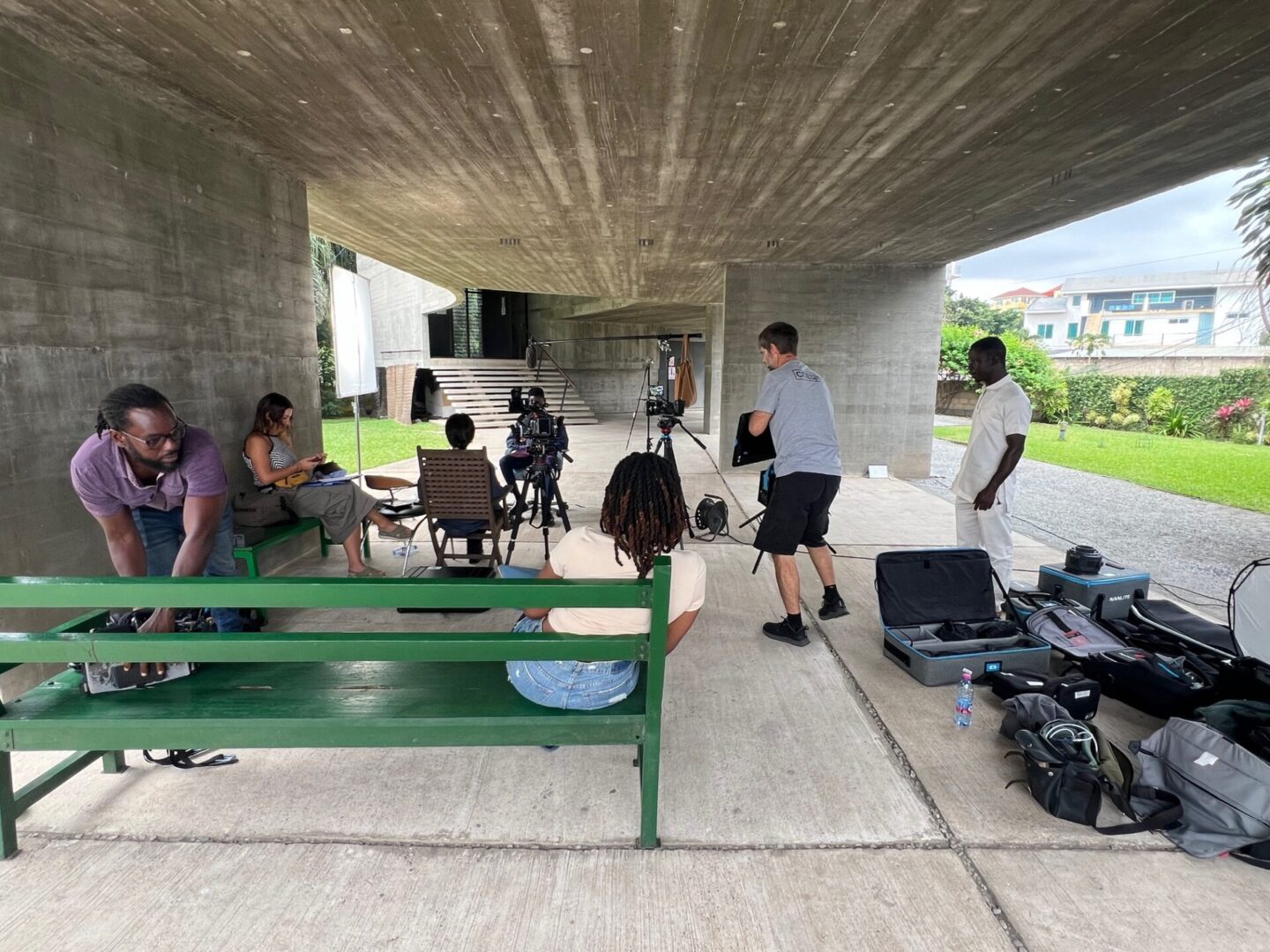 Film crew setting up equipment outdoors