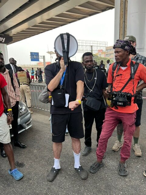 Person holding megaphone surrounded by onlookers