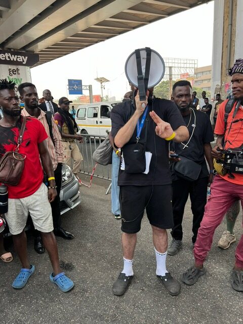 Group of people gathered under bridge