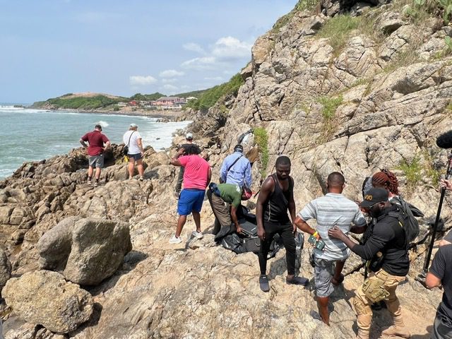 Tourists on rocky beach path