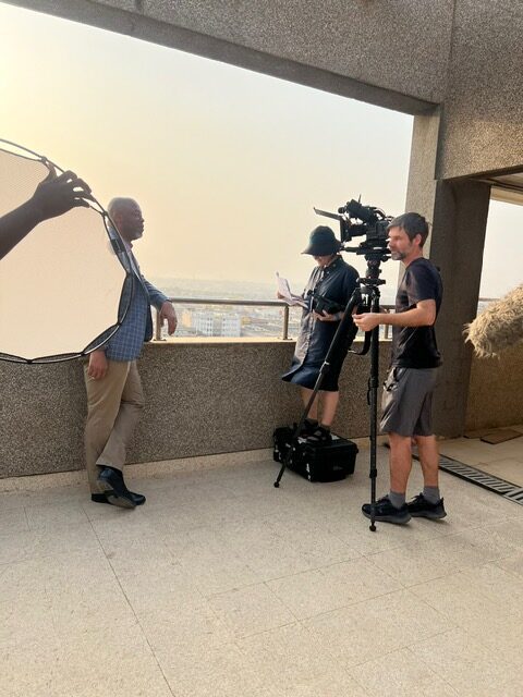 Cameraman recording on a balcony