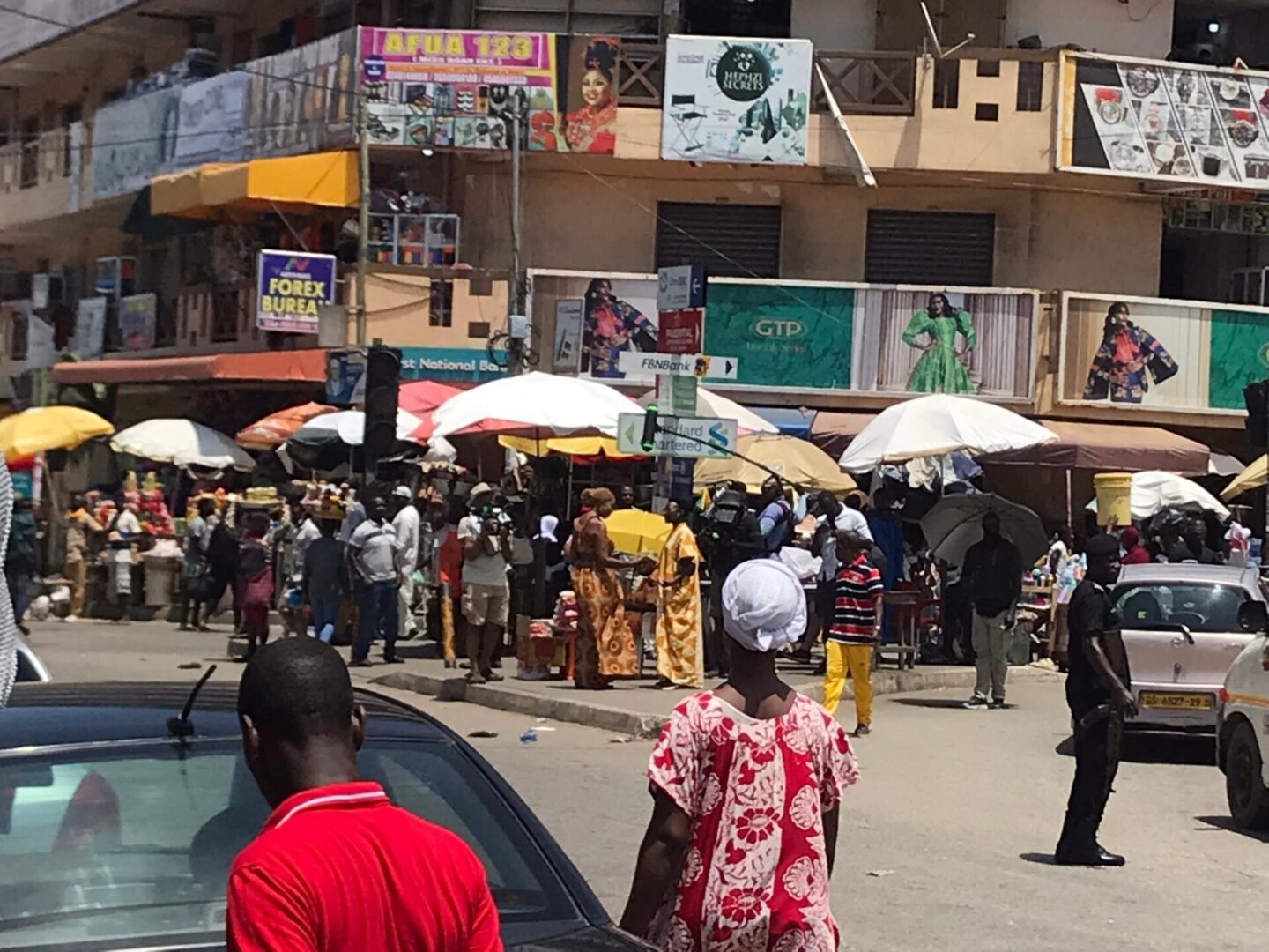 Crowded marketplace with colorful umbrellas