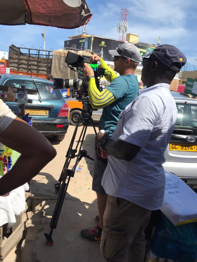 Filmmakers capturing scene in urban area